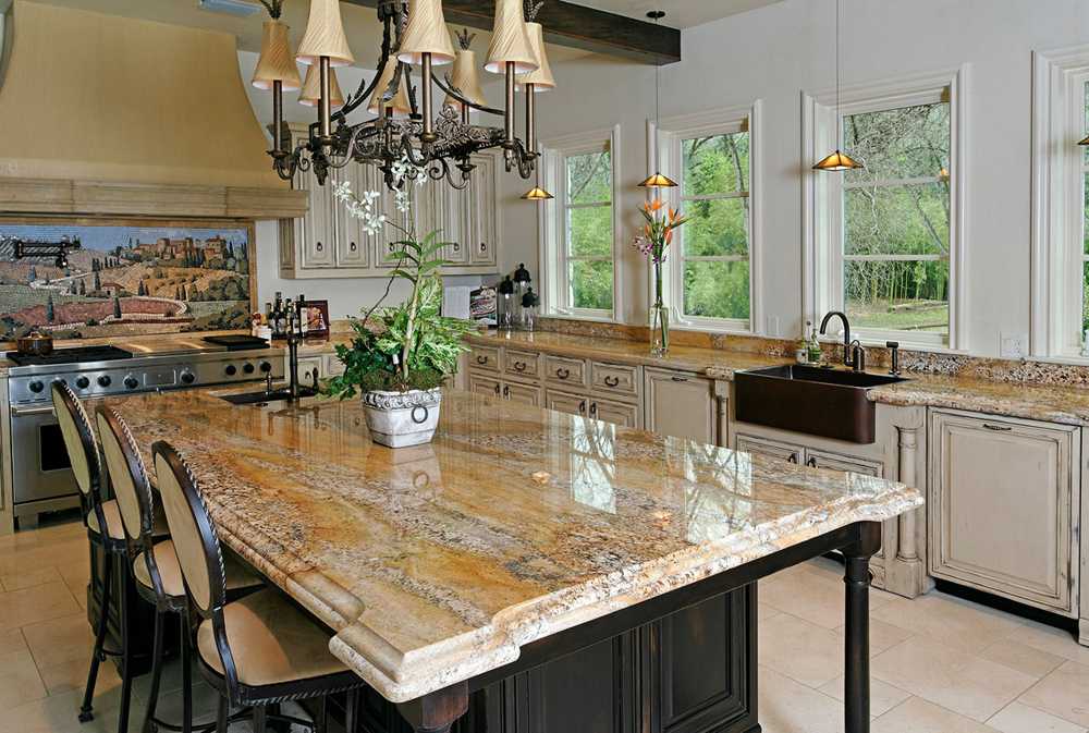 Kitchen island countertop in brown veined stone with a stepped decorative edge profile