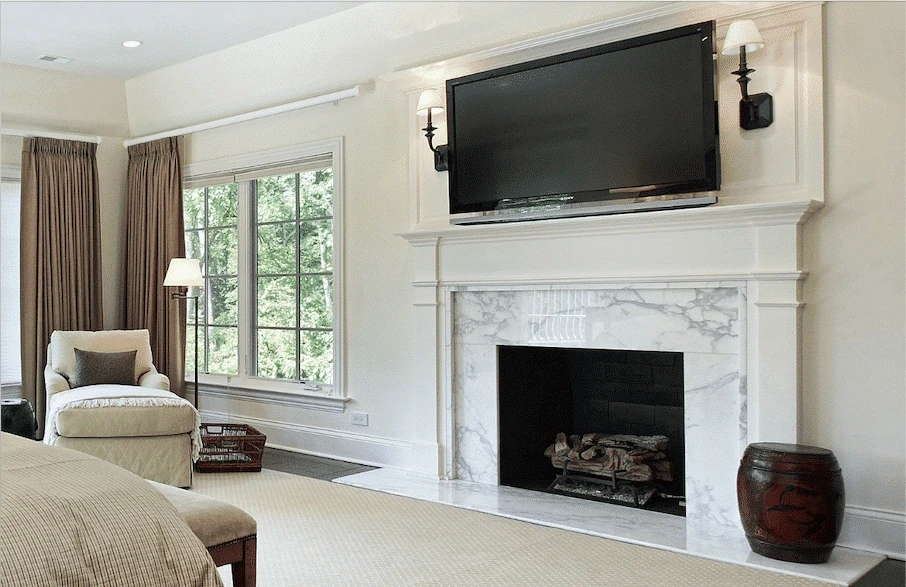 Stone fireplace surround in white with gray veining and a TV mounted above the mantel