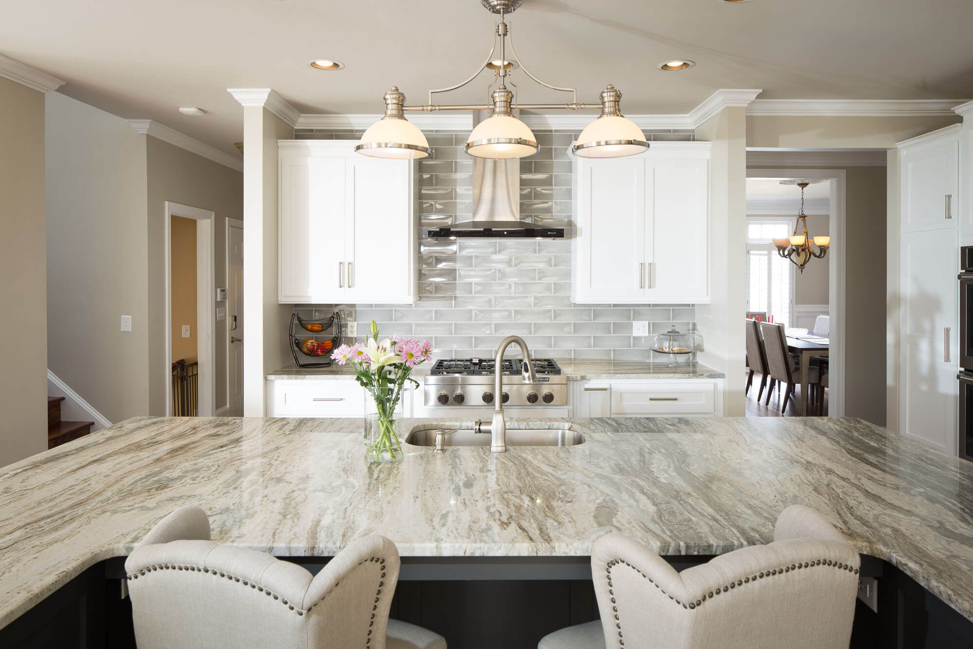 Kitchen island with granite countertop in beige and gray with swirling dark veining