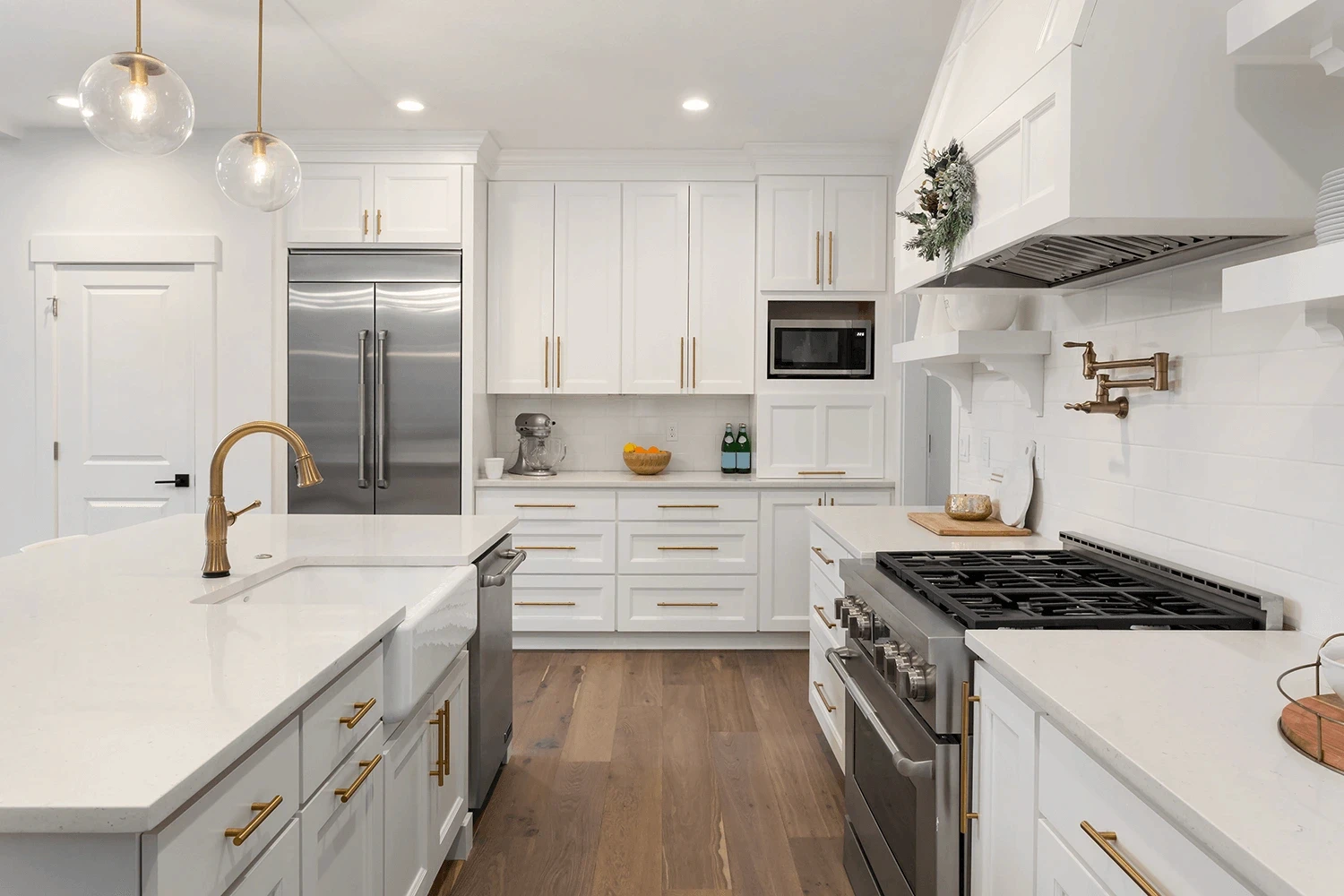 Kitchen island and perimeter countertops in white stone with subtle light gray speckles