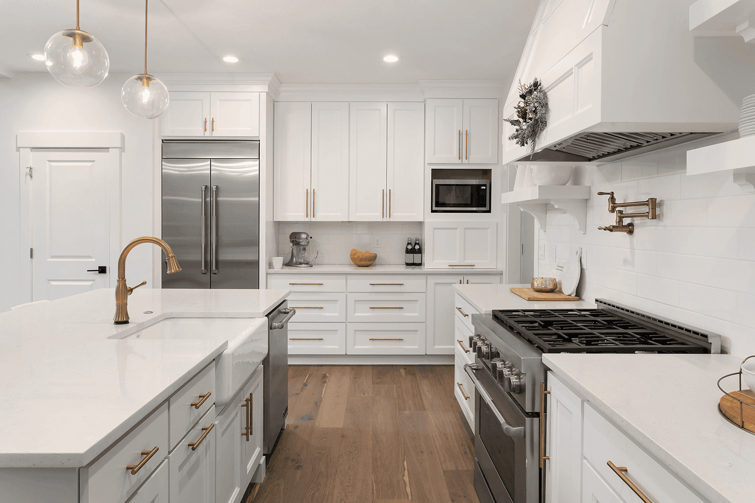 Kitchen with island and wall countertops in white stone with subtle gray pattern